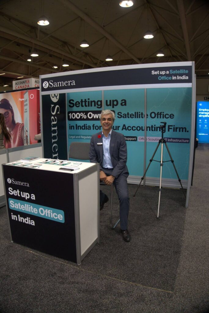 Arun sitting at a Samera Stand
